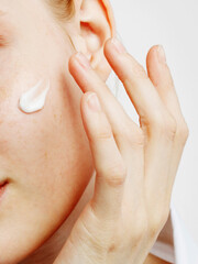 Close up of the face of a beautiful girl with perfect skin and clean all impurities thanks to moisturizing creams both anti-aging and night and day.