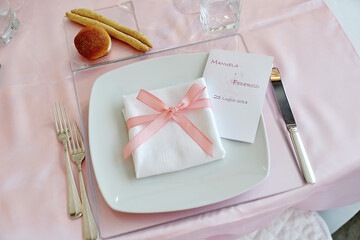Detail of a table set in pink for a wedding banquet