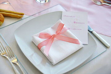 Detail of a table set in pink for a wedding banquet