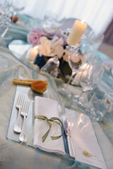 Detail of a table set in sea water color organza for a wedding banquet