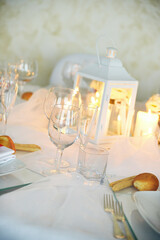 Detail of centerpiece with lantern flowers and candles for wedding banquet