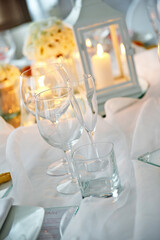 Detail of centerpiece with lantern flowers and candles for wedding banquet
