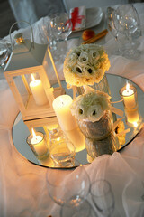 Detail of centerpiece with lantern flowers and candles for wedding banquet