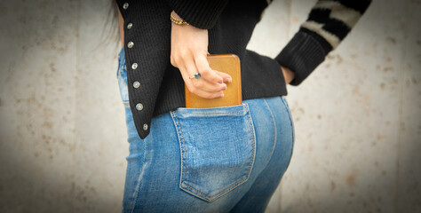 Woman with mobile phone in back pocket.