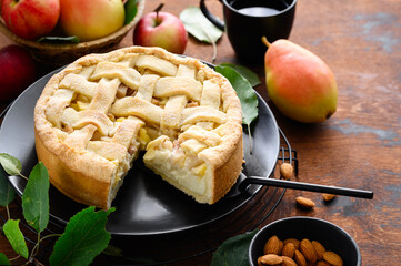 Pear pie with custard almond cream on a wooden table.  Autumn bakery. Selective focus. Copy space