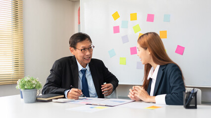 Business partnership concept, Senior in business is explaining and discussing project with partner