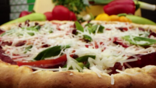 Close-up is a slice of freshly baked pizza with delicious elastic cheese. Delicious Italian pizza from the oven on a background of tomato, spices and cheese. food and drink 4k footage