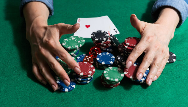 woman hand on green poker table with chips