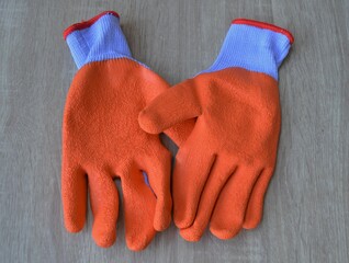 Rubber work gloves on wooden background, protective equipment