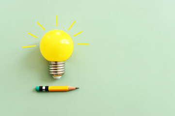 Education concept image. Creative idea and innovation. light bulb metaphor over green background 