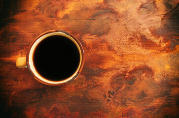 Top view image of coffee cup over wooden table background.