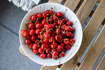 bowl full of fresh, ripe cherries from the home garden without chemical spraying