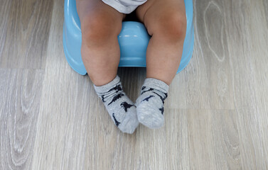 first sitting on the potty of a small child and trying to go to the toilet