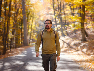 Obraz premium Young handsome man posing in autumn forest.