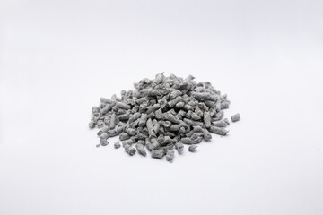 shallow depth of field photo of recycled Paper cat litter pellets on a white background