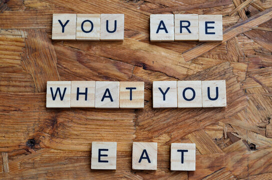 you are what you eat text on wooden square, motivation quotes