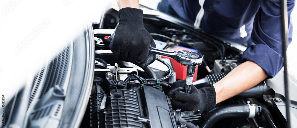 Wall mural automobile mechanic repairman hands repairing a car engine automotive workshop with a wrench, car se