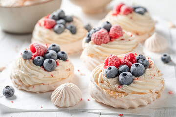 Sweet and crunchy Pavlova dessert with whipped cream and fruit.