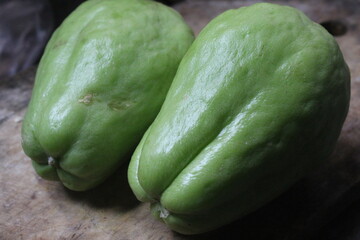 Chayote is a light green fruit with a pear-like shape with one large opening and edible flesh and skin.