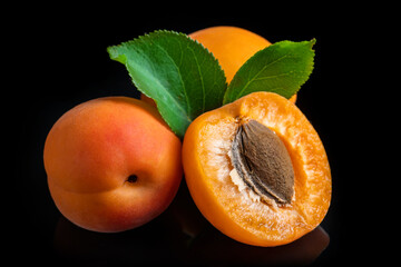 Apricot fruit with leaf isolated on black background.