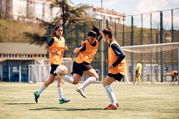 Skillful female soccer player in action during sports training at stadium.