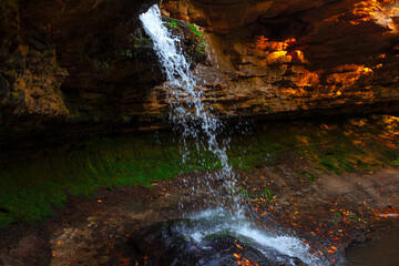 Fototapeta na wymiar Rock waterfall . Natural water cascade in autumn 