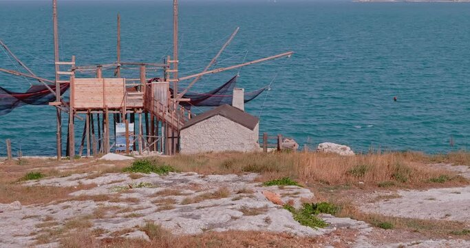 Trabucco, (Trebuchet) overlooking the Adriatic sea, a traditional Italian wooden fishing house. Stilt house for fishing on Apulian coast. Vieste - Italy