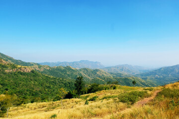 Naklejka premium Mountain scape at Khao Kho National Park & Hot Springs in the morning at Phetchabun of Thailand in Winter, Sunny day and blue sky, Beautiful Natural View in Thailand, Natural wallpaper and background