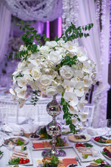 Bouquet of flowers in vase on the wedding table