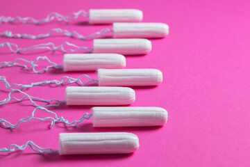 Menstrual period concept. Woman hygiene protection. Cotton tampons on pink background.