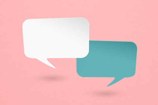 Conceptual image about communication and social media, two blank white and blue speech bubble paper cut on grunge pink paper background