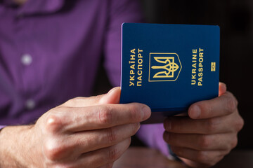 New ukrainian blue biometric passport with identification chip in hands