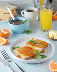 Sandwiches with marmalade, orange juice and coffee ready for breakfast	