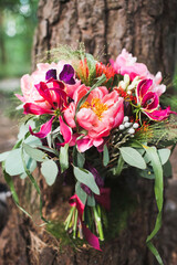 Colorful wedding bouquet on a tree in the garden