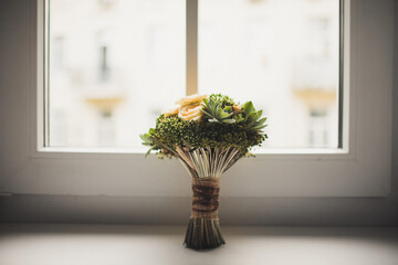 Colorful wedding bouquet on a wooden window sill