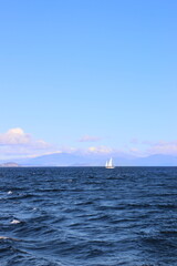 Lake Taupo with sailboat. View to snowy mount Tongariro	
