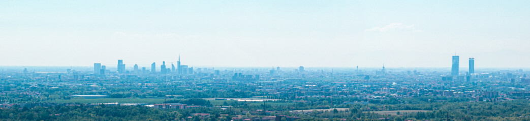 Aerial view of the new Skyline of Milan seen from the Milanese hinterland. Sky with mist that envelops the skyscrapers of the Lombard capital
