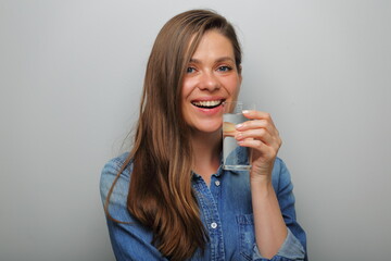 Water with clear glass smiling woman holding near her face. isolated female portrait.