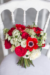 Wedding bouquet stands on a wooden chair