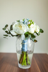 Wedding bouquet stands in a vase with water