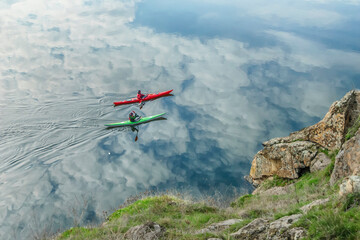 Fototapeta na wymiar Two boats on the background of the reflection of clouds in the water