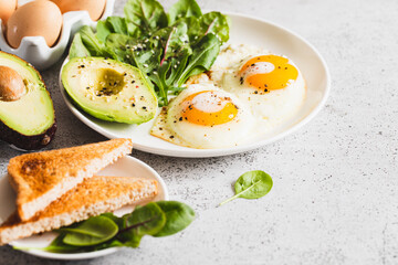 Healthy Breakfast with Wholemeal Bread Toast, Eggs with Green Salad, Avocado. traditional breakfast