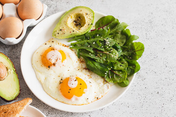 Healthy Breakfast with Wholemeal Bread Toast, Eggs with Green Salad, Avocado. traditional breakfast