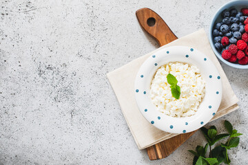 Homemade Cottage cheese with berries and mint. Cottage cheese in a bowl. Dairy products.