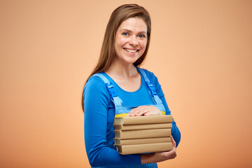 Woman worker or student in overalls standing with books stack. isolated on beige.