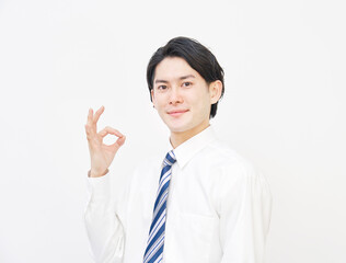 白バックでOKのジェスチャーをするビジネスマン