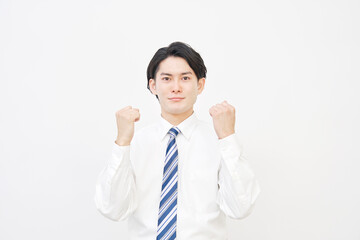 白バックでガッツポーズするビジネスマン