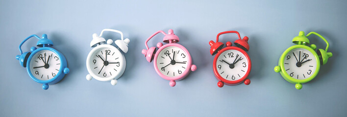 multicolor Alarm clock on a blue background , time management concept