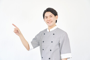 左側を指差しする男性パティシエ　白背景