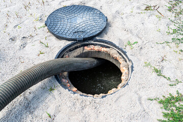 A four-inch suction pipe inserted into a home septic tank, suction of household wastewater.